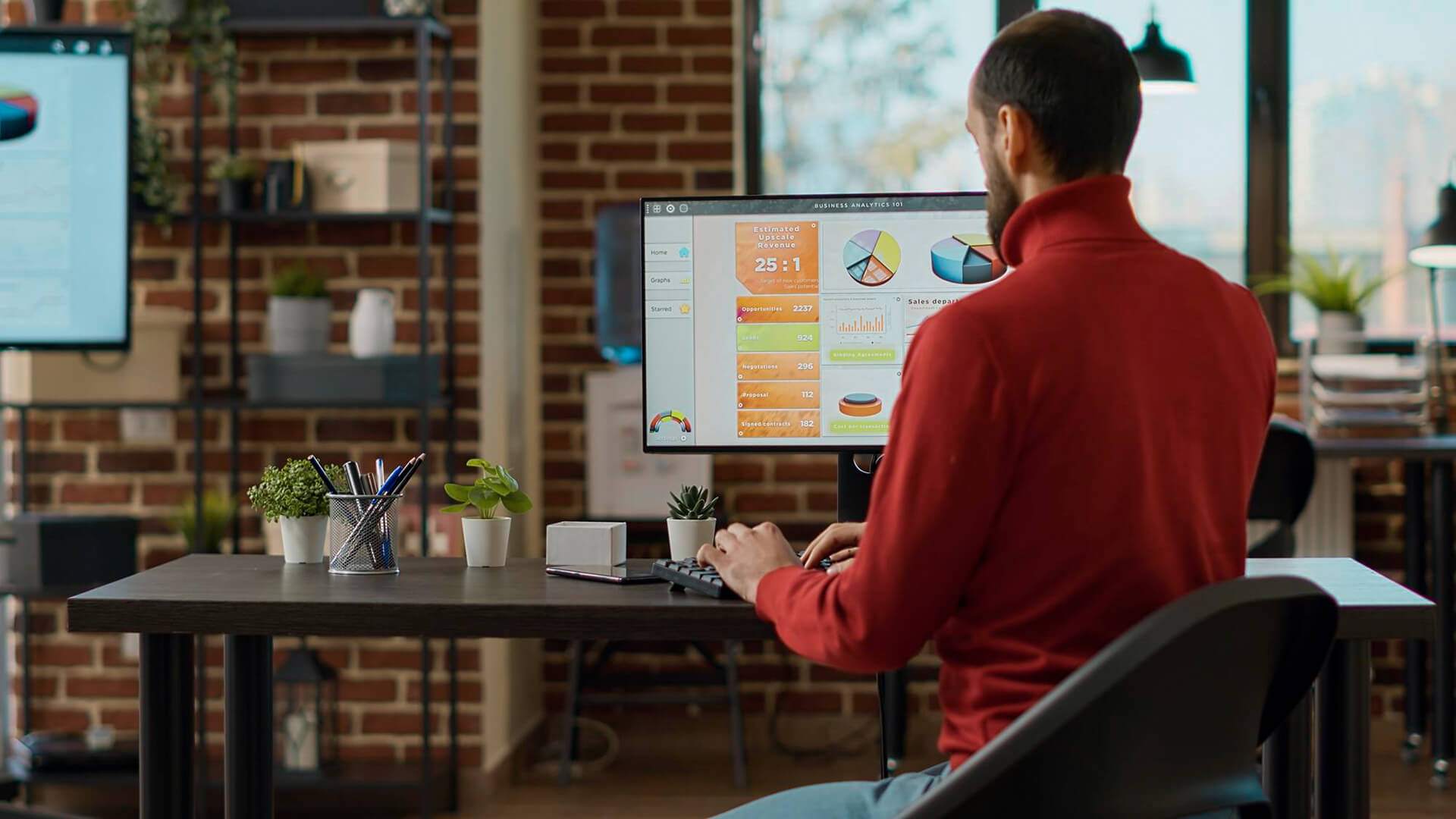 consultant checking company stats on his monitor